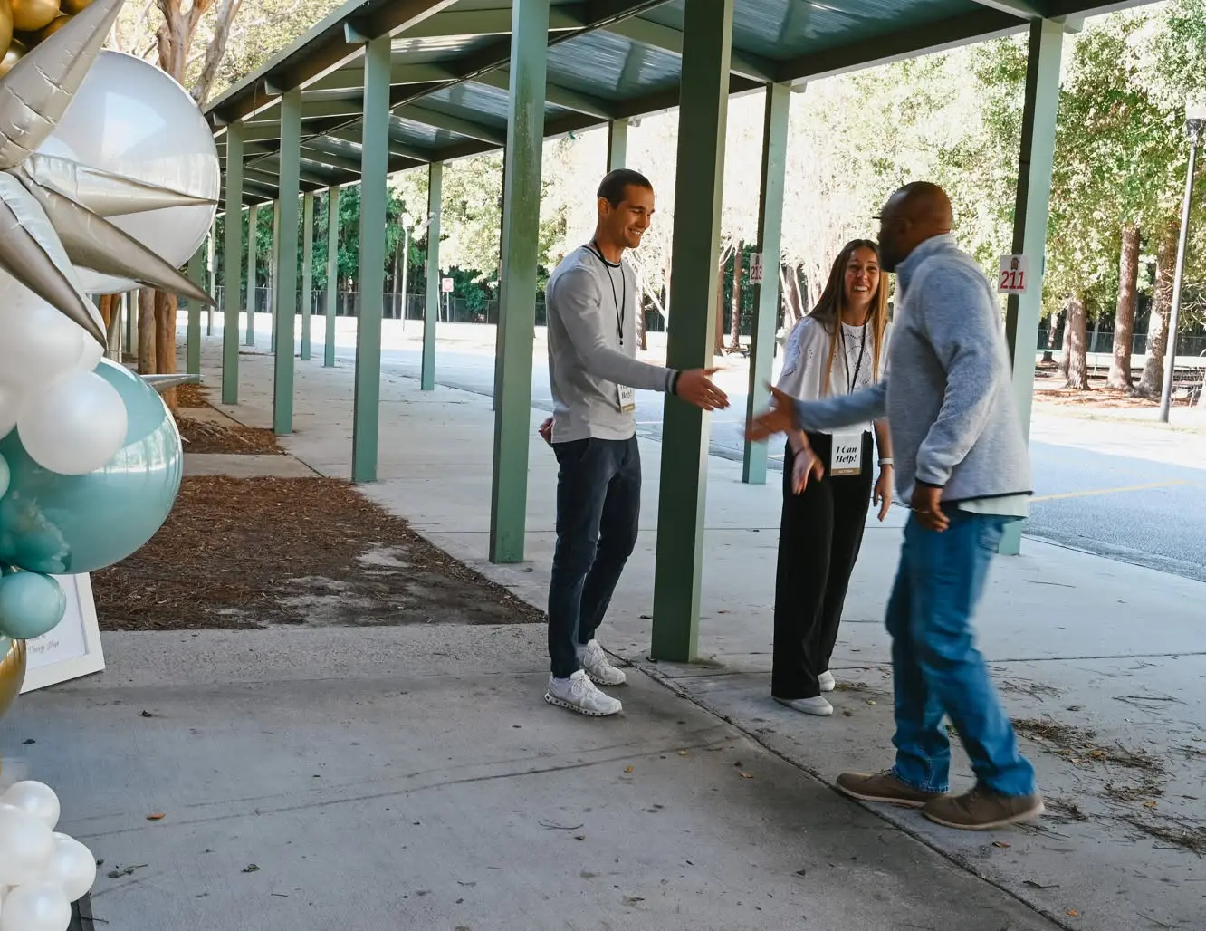 Greeters welcoming people on the covered walkway at Laurel Hill Primary School